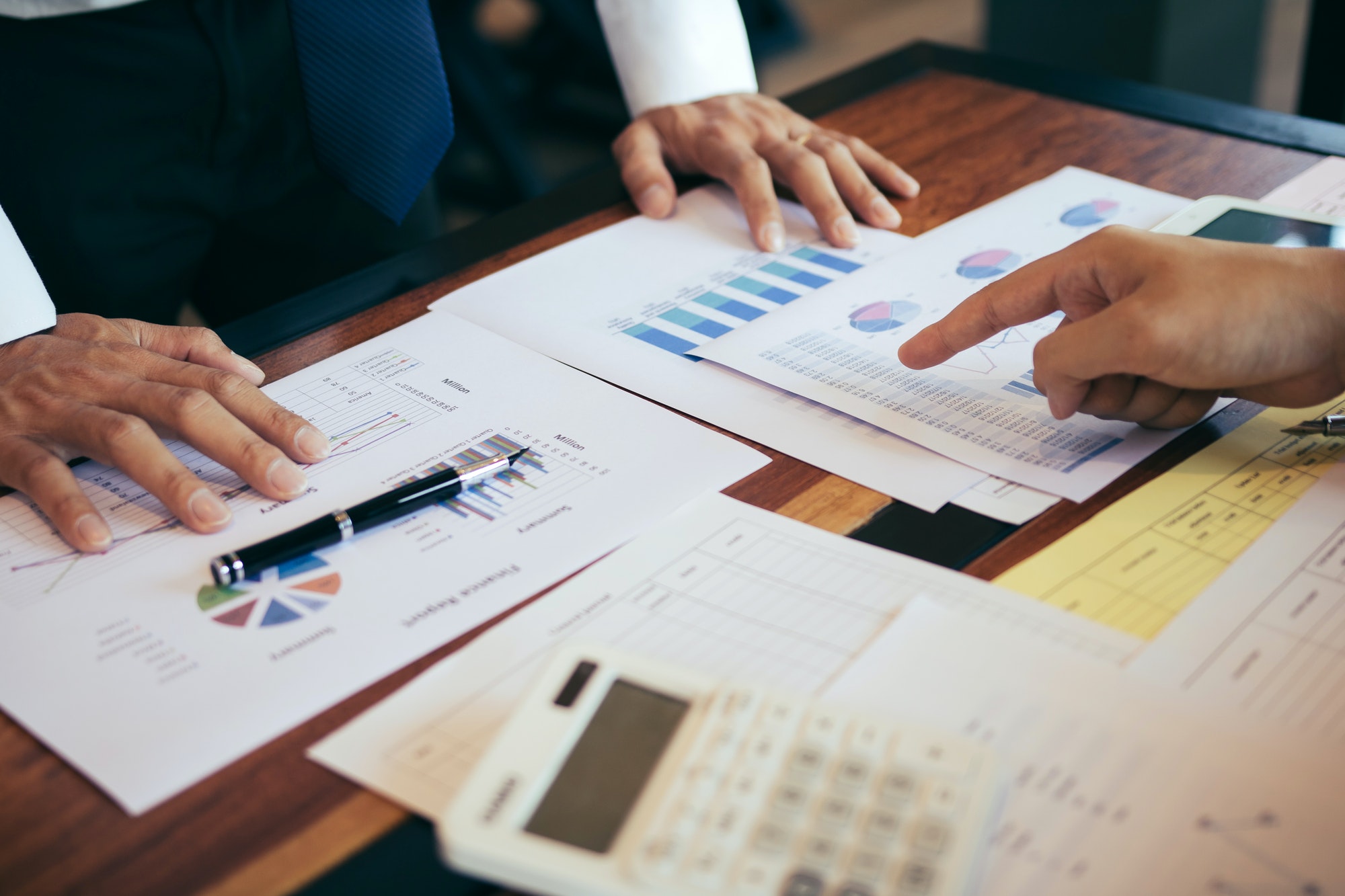 Business people pointing on statistic number result and analysis finance cost with checking summary